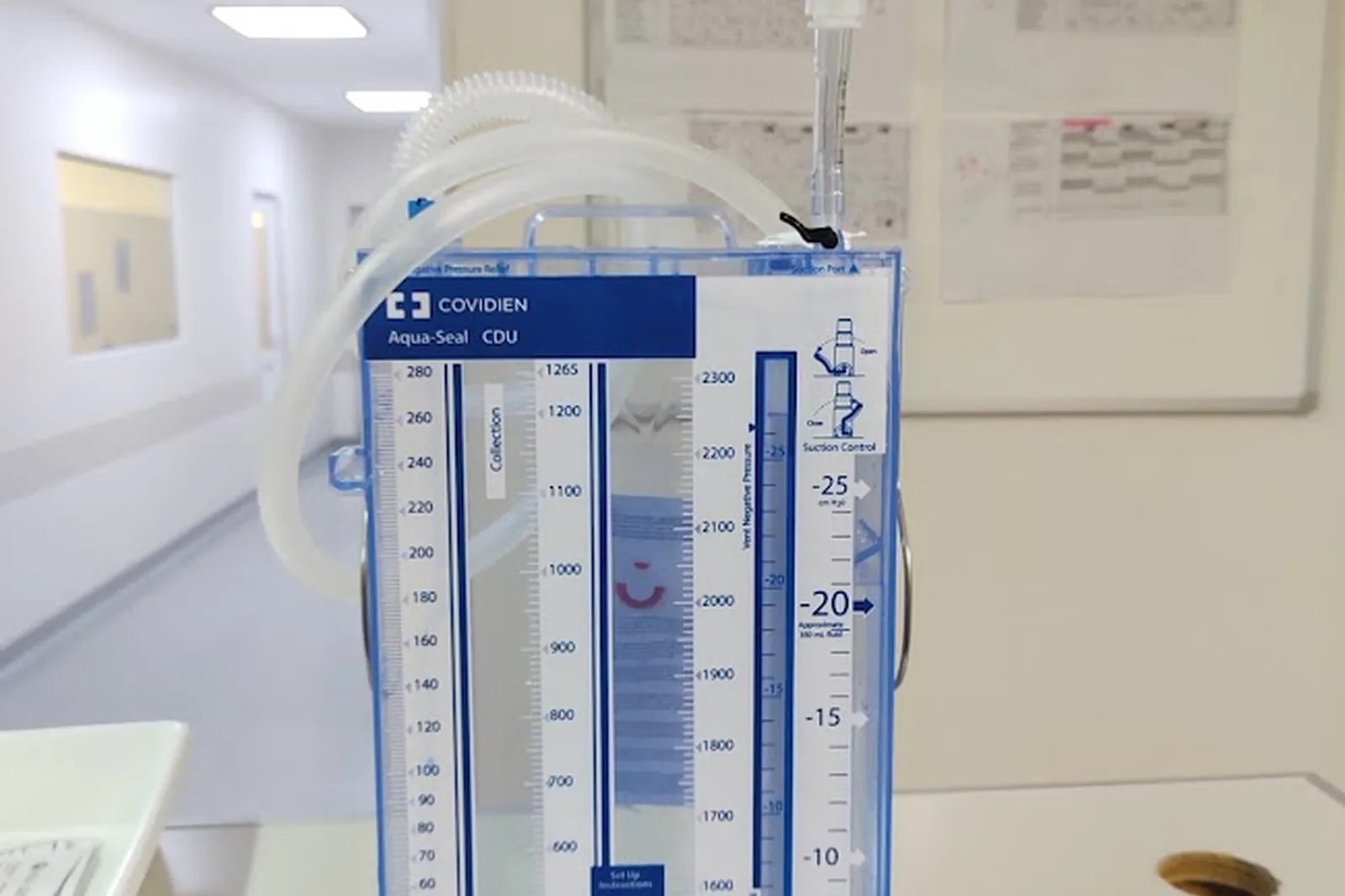 Sistema de drenaje pleural con sus columnas graduadas, al lado de la cama.